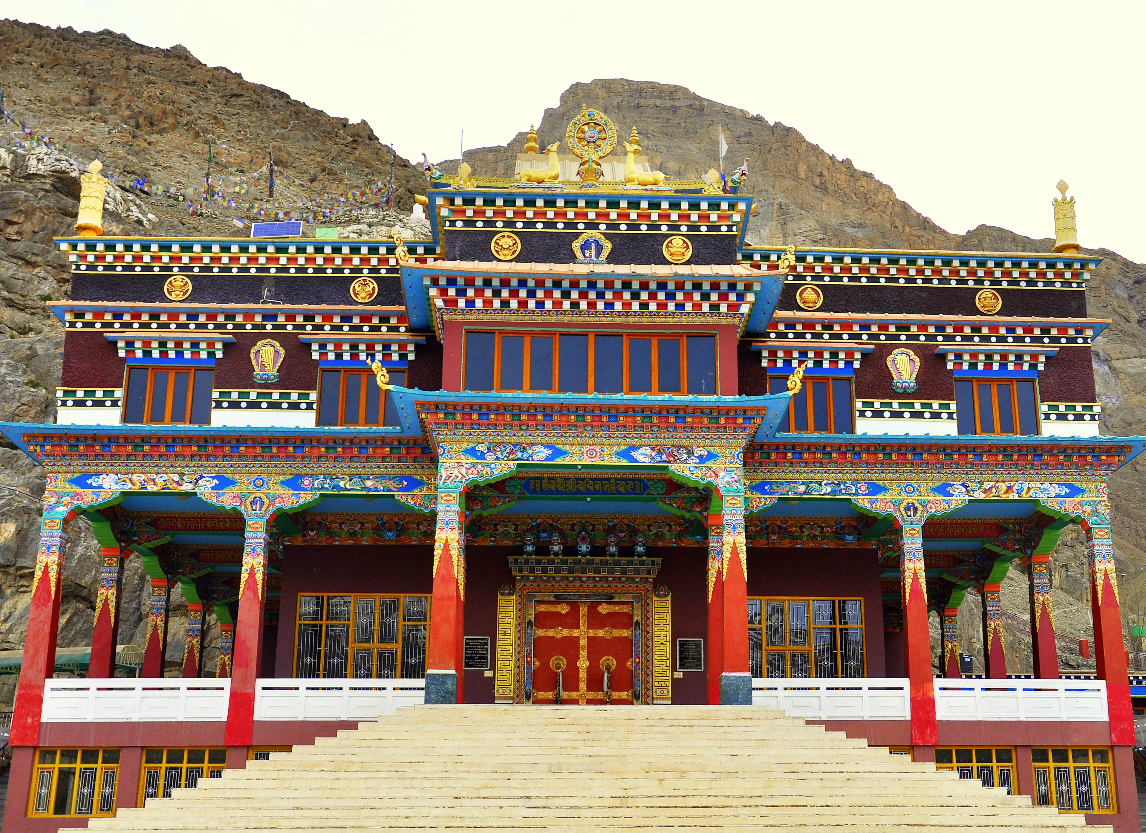Snow-covered Spiti Valley cold desert with a monastery below Himalayan peaks in winter